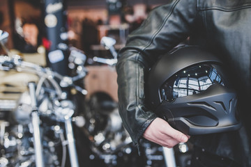 man holding motorcycle helmet