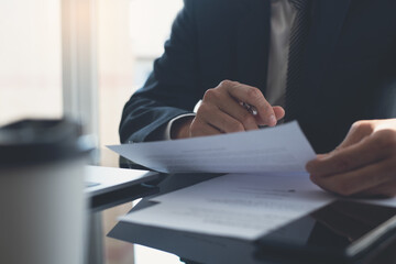 man holding document and pen