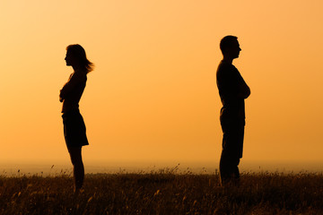 woman and man silhouettes looking away from each other