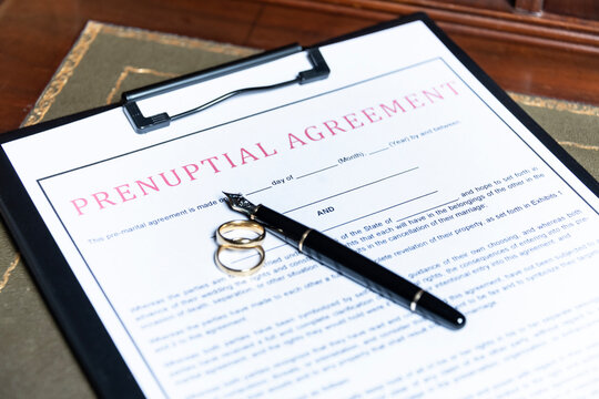 prenuptial agreement with rings and a pen