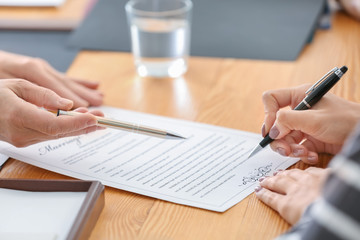 person signing prenuptial agreement