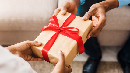 two people holding opposite ends of gift