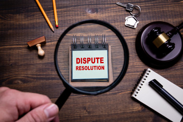 magnifying glass over paper that says dispute resolution