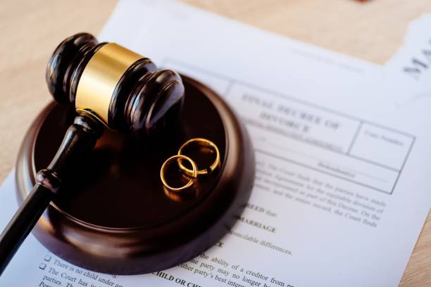 gavel and wedding rings ontop of paperwork