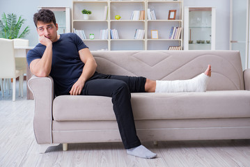 man with broken leg looking sad