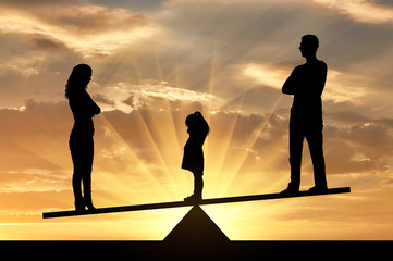 silhouette of parents and child standing on seesaw