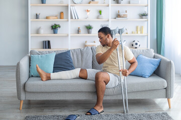 man with broken leg on couch