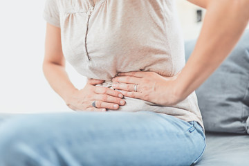 woman clutching stomach in pain
