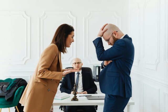 couple fighting in front of lawyer