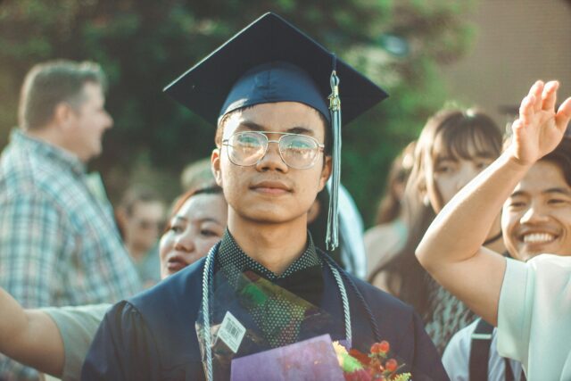college student in graduation cap and gown