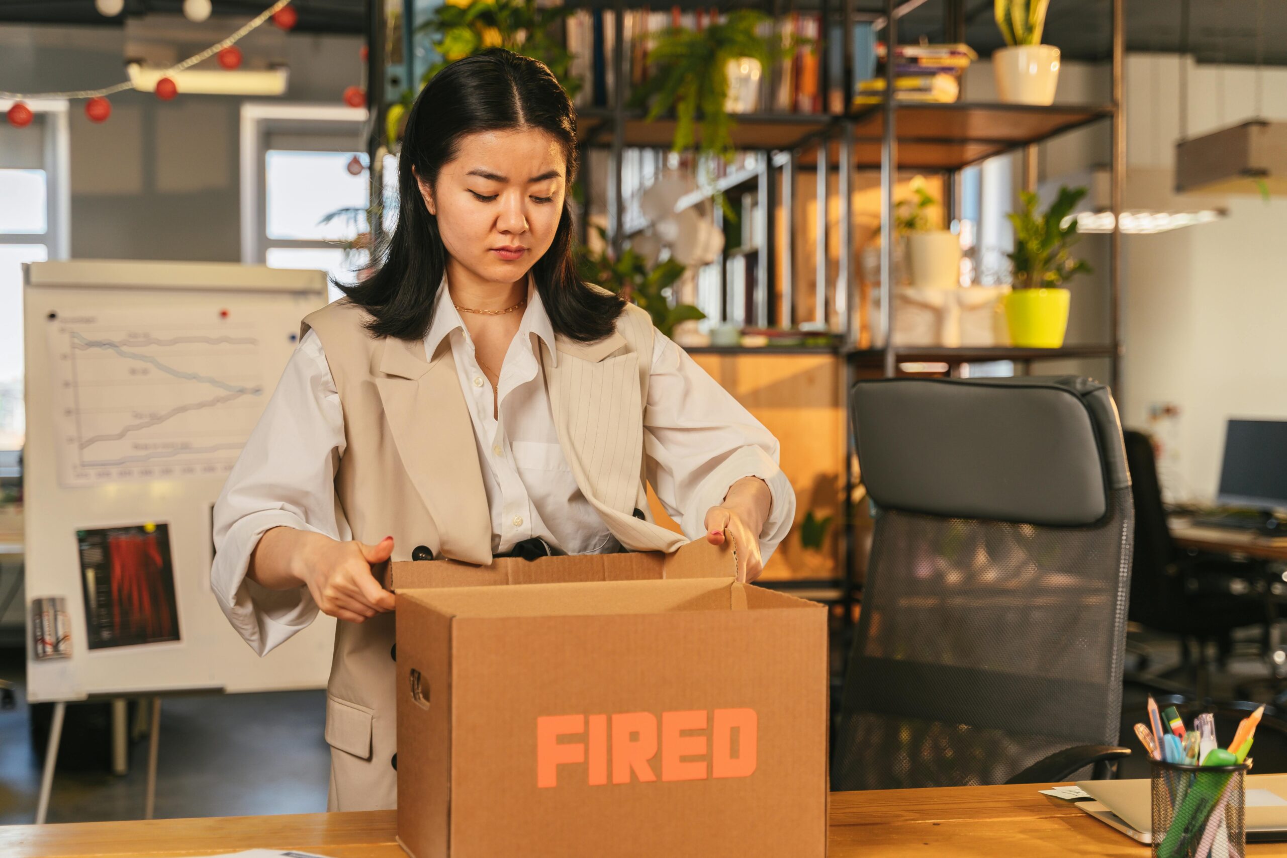 woman with box that says fired